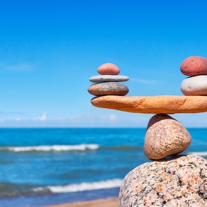 Concept of harmony and balance. Balance stones against the sea. Rock zen in the form of scales